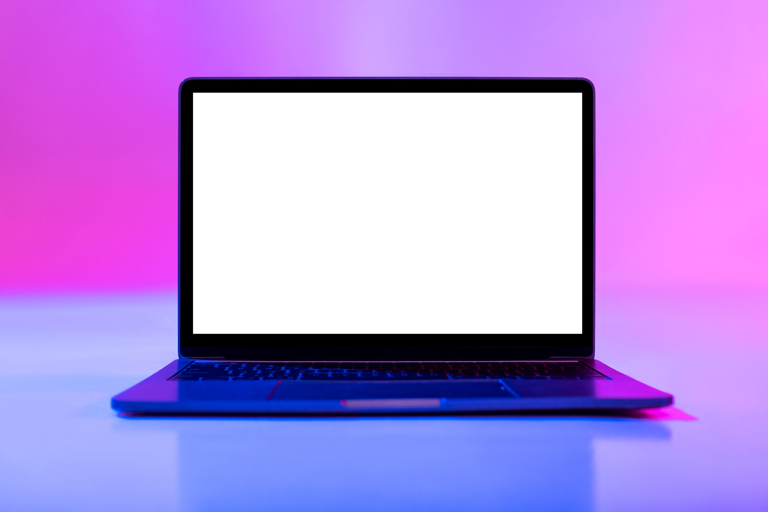 Laptop computer with blank white screen in neon light, mockup for desktop or website. Modern portable pc with empty space for your advertisement. Graphic user interface template